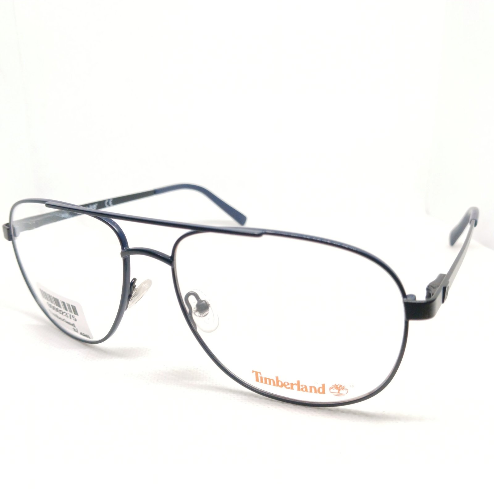 Montura de gafas Timberland aviador azul marino con barra superior y lentes transparentes sobre fondo blanco